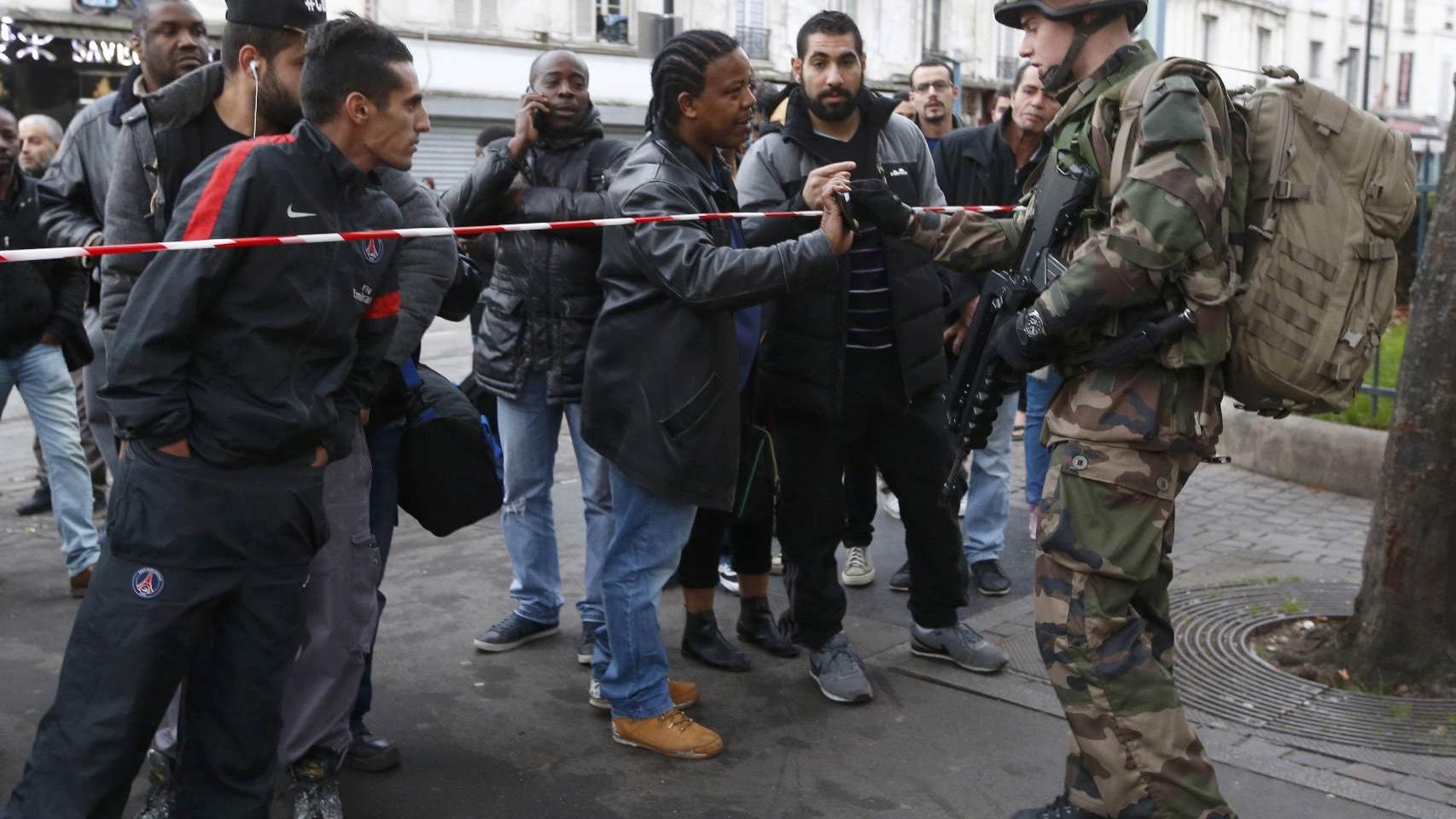 Un soldado comprueba la identidad de un vecino que quiere cruzar un control.