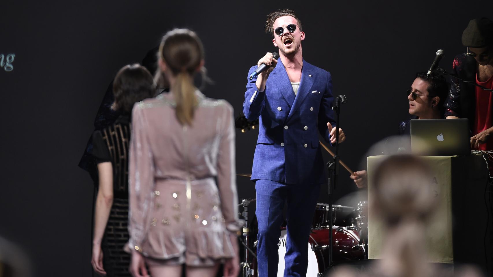 Aldo Comas cantando en directo con su grupo San Leon en el desfile de Teresa Helbig