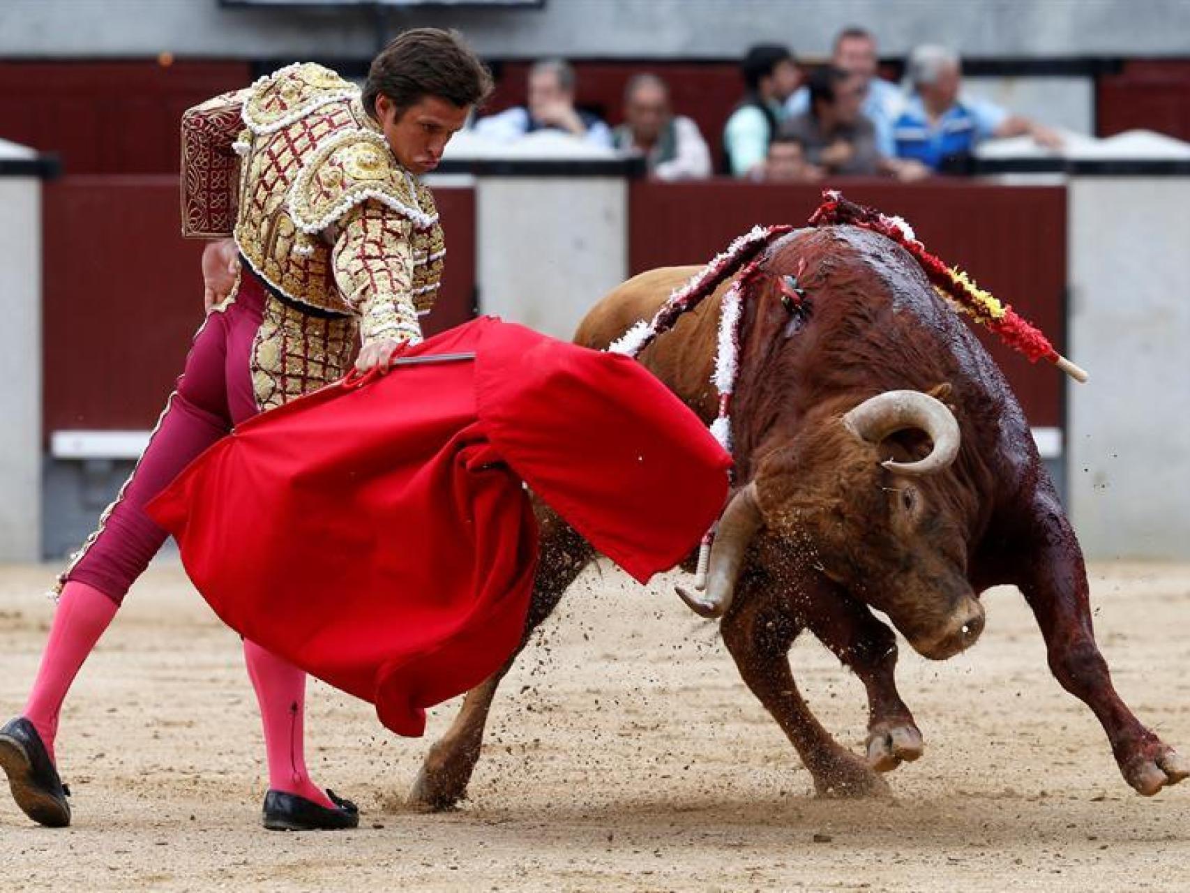 El Juli da un pase con la muleta a su primero.