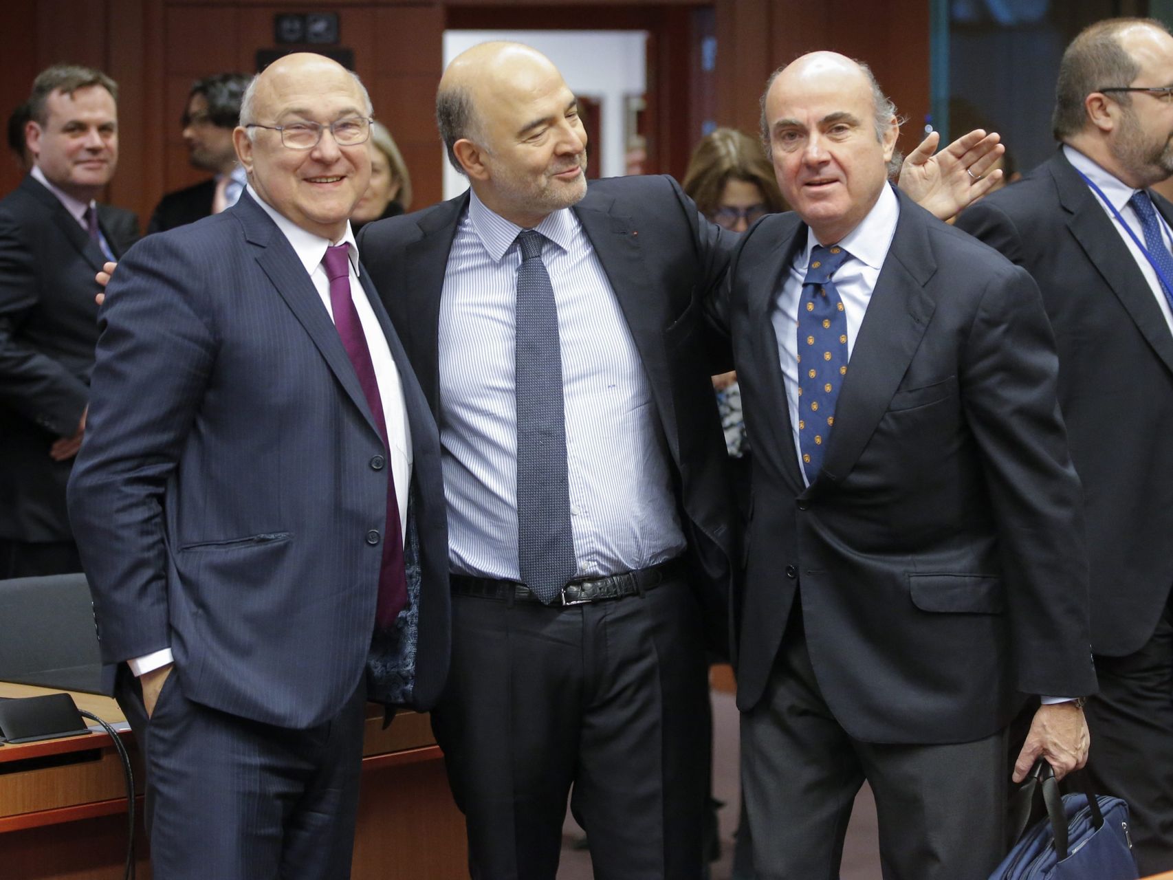 Guindos posa con Moscovici y el ministro francés Michel Sapin al inicio del Eurogrupo