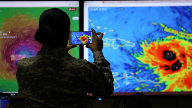 Un miembro del Comité de Operaciones de Emergencia (COE) fotografía la trayectoria del huracán María en Santo Domingo