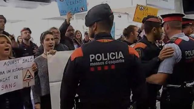 Los Mossos defienden el 'estand' del Ejército en el Salón de la Enseñanza de Barcelona.