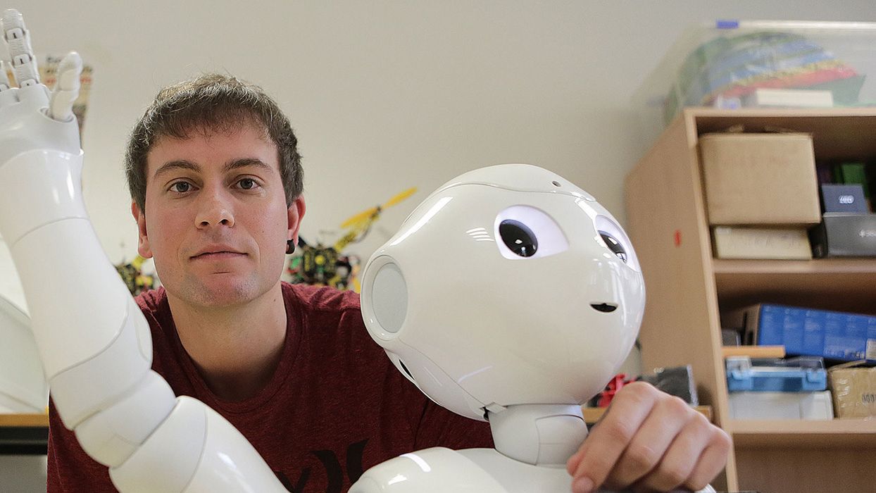 Igor Rodriguez, autor principal del trabajo, junto a un robot humanoide.