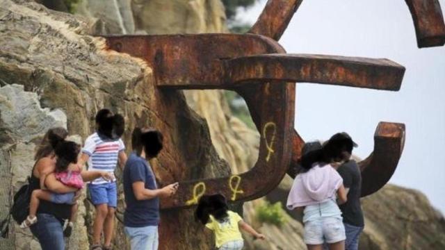 Una de las esculturas del Peino del Viento ha amanecido con pintadas de lazos amarillos.