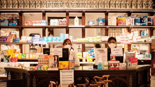 Mari Luz y Cristina tras el mostrador de la Farmacia de la Reina Madre, en Madrid.