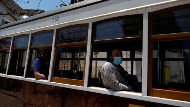 Viajeros con mascarilla en un tranvía de Lisboa.