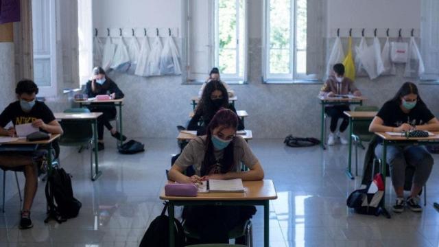 Estudiantes en su clase con mascarilla.