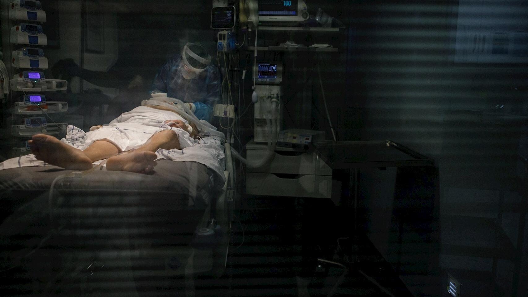 Personal sanitario atiende a un paciente con Covid-19 en una UCI. EFE/Ramón de la Rocha