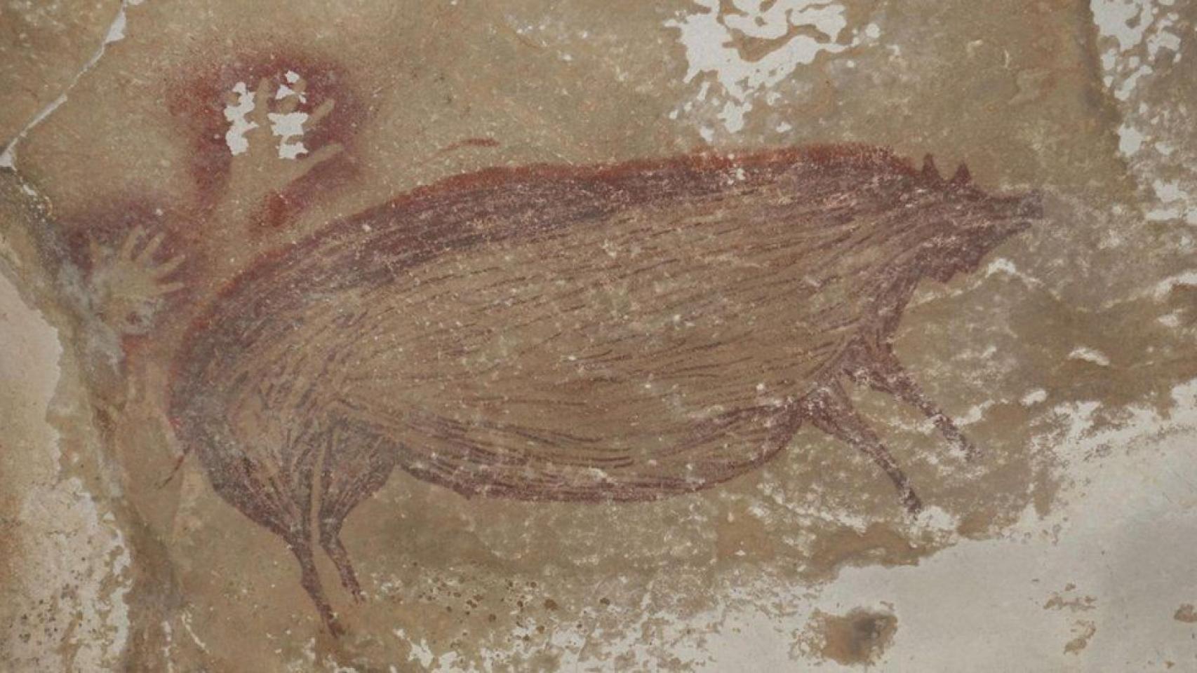 Dos manos y la representación de un cerdo.