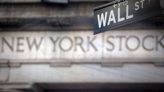 FILE PHOTO: A Wall Street sign outside the New York Stock Exchange