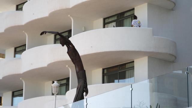 Un joven en un balcón del hotel Palma Bellver, donde estaban confinados 249 jóvenes.