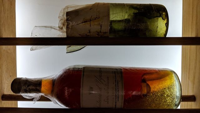 La botella original que se rompió y la botella recorchada que contiene el vino de la original