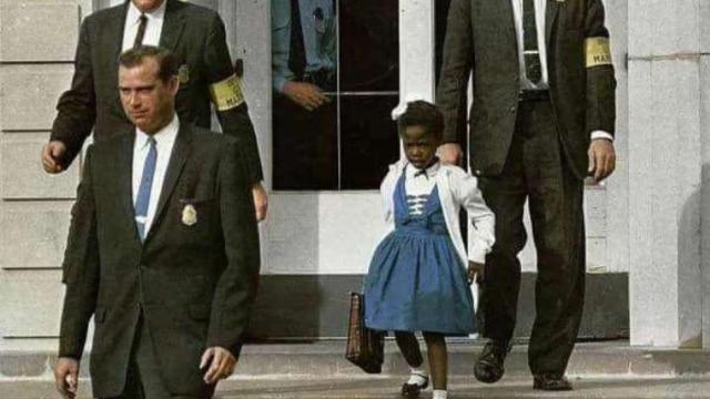 Ruby Bridges escoltada por agentes federales a la salida de la escuela en 1960.