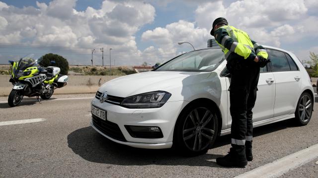 Un agente de la Guardia Civil sancionando a un conductor.
