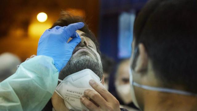 Un sanitario realiza un test de antígenos a un ciudadano.