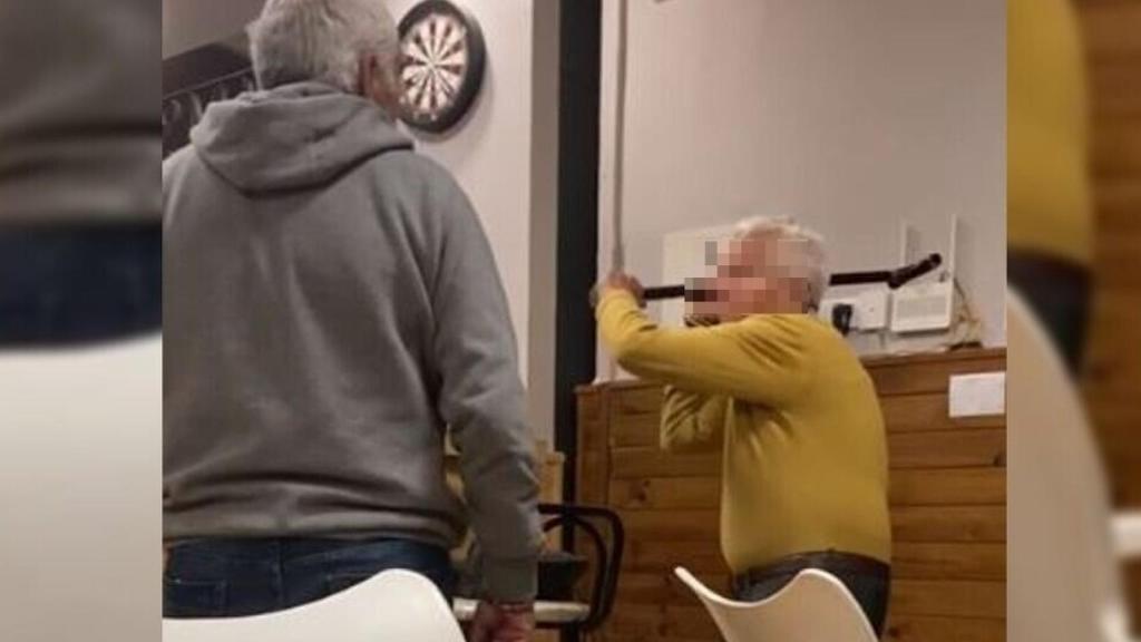 Instante en el que el anciano levanta el bastón para agredir al hombre.