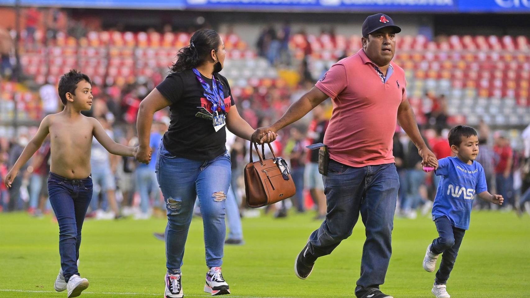 Una madre y un padre huyen con sus dos hijos pequeños de la batalla entre ultras del Querétaro y Atlas