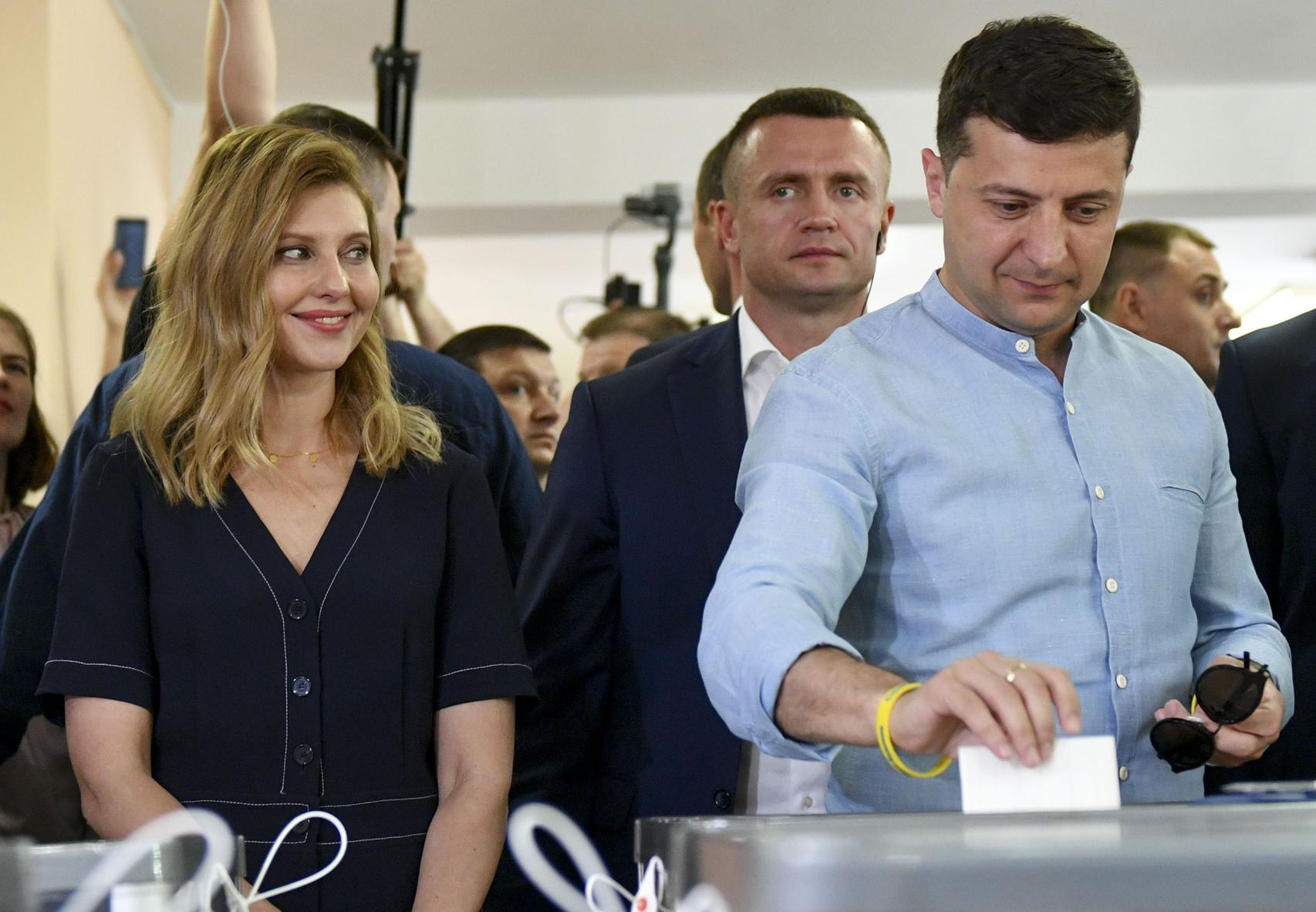 El presidente de Ucrania, Volodímir Zelenski, vota en las elecciones parlamentarias del 21 de julio de 2019 ante la cómplice mirada de la primera dama, la guionista Olena Zelenska. Arriba, el vídeo en el que han confundido a la cantante inglesa Connie Talbot y el estadounidense Alejandro Manzano con la pareja presidencial ucraniana por su parecido físico.