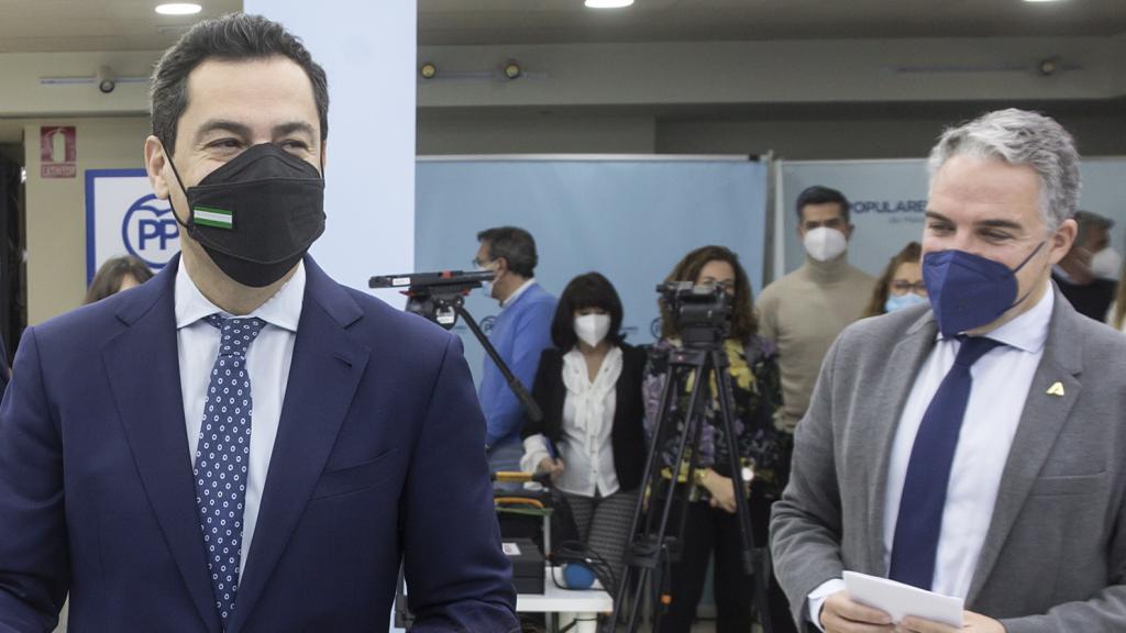 Juanma Moreno votando este lunes en la sede del PP de Málaga junto a Elías Bendodo.