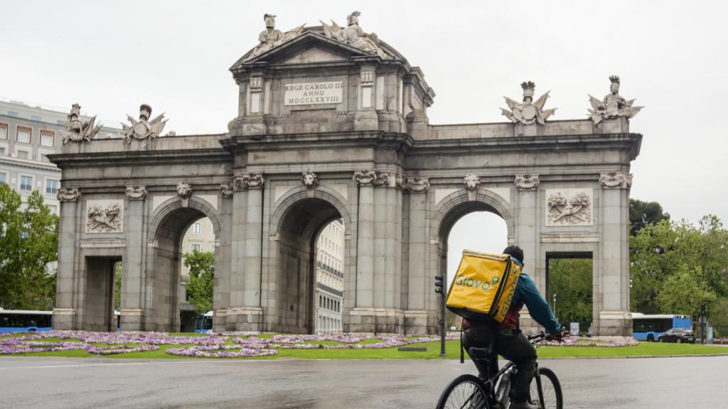 Un 'rider' circulando por los alrededores de la Puerta de Alcalá (Madrid) en mayo de 2020.