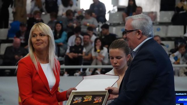 Una representante del comité olímpico ucraniano recoge la placa del evento.