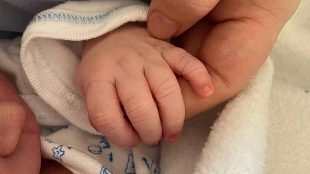 Paula Juan agarra la mano de su pequeño hijo Martín.