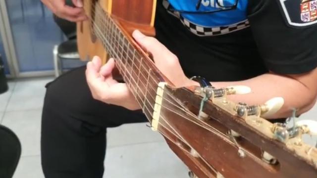 Imagen del policía tocando la guitarra