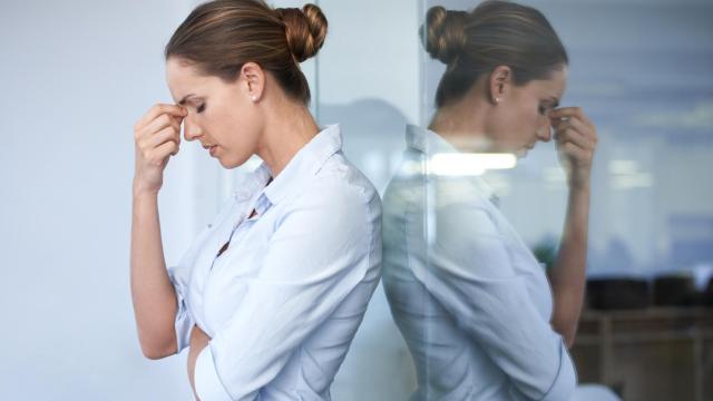 Una mujer con dolor de cabeza por el estrés.