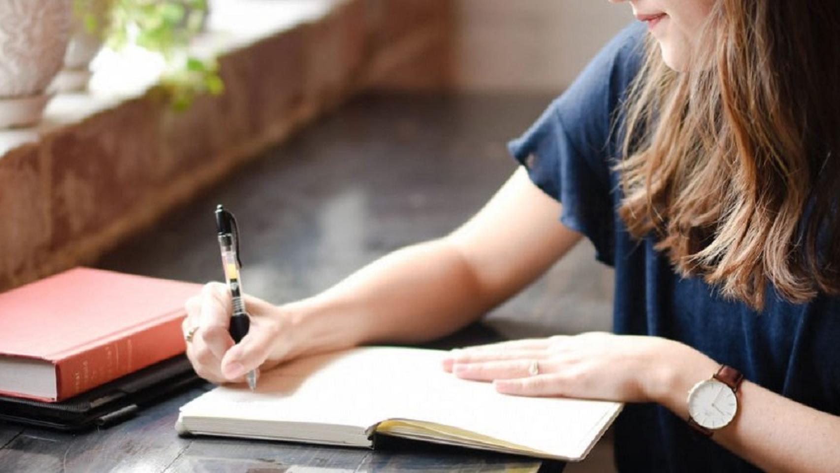 Una mujer escribiendo.