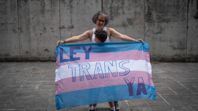 María José y Antonio, envueltos en la bandera trans.