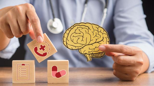 Doctor,Holding,A,Brain,Shape,Made,From,Yellow,Paper,And