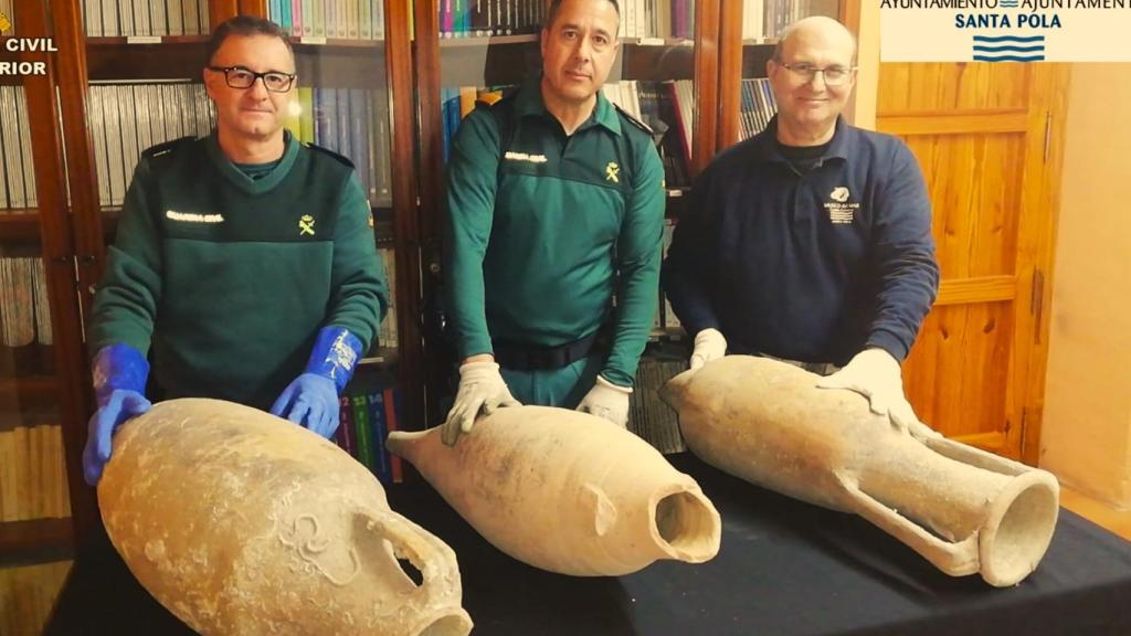 Los técnicos del Seprona y el municipal muestran las tres ánforas romanas recuperadas en Santa Pola.
