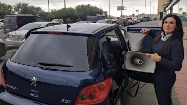 María Jesús Álvarez, chófer del 'coche de los muertos', este miércoles, en Molina de Segura, colocando la megafonía en un Peugeot para radiar la defunción de una vecino.