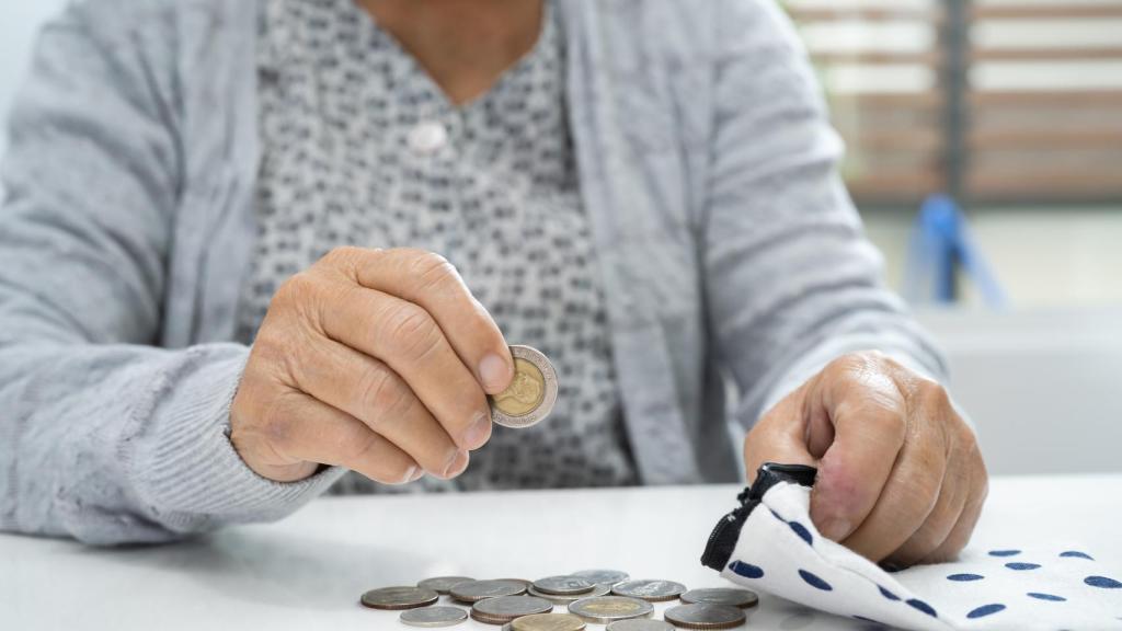 Una mujer contando monedas en una imagen de archivo.