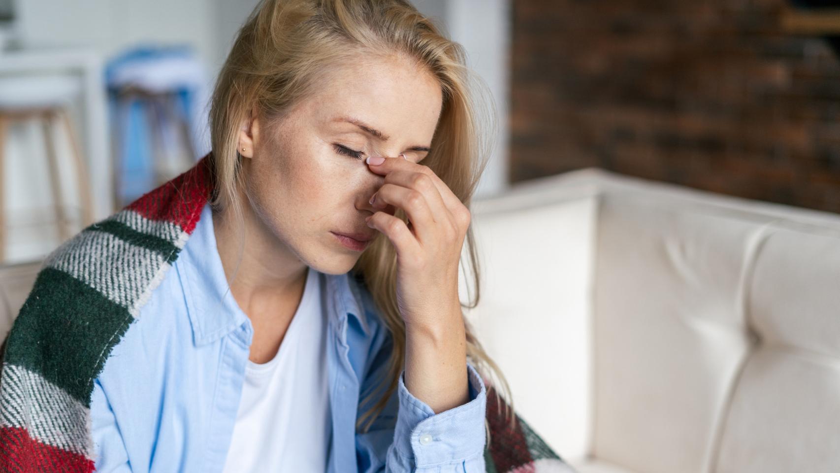 Una mujer sufre dolor y cansancio.