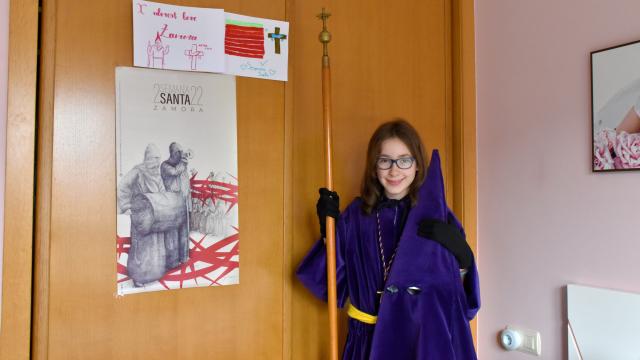 Nerea posa con su hábito de la Vera Cruz en su habitación