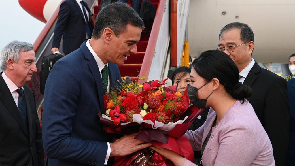 El presidente del Gobierno, Pedro Sánchez, recibe un ramo de flores a su llegada al aeropuerto internacional de Pekín (China), en marzo de 2023.
