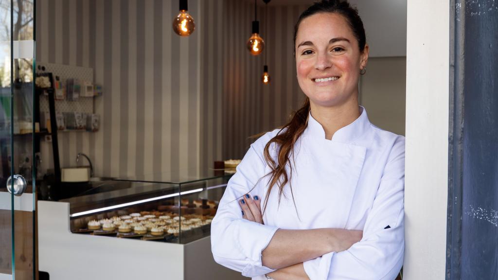 Fran Bravo en la entrada de la pastelería con el mostrador de fondo.