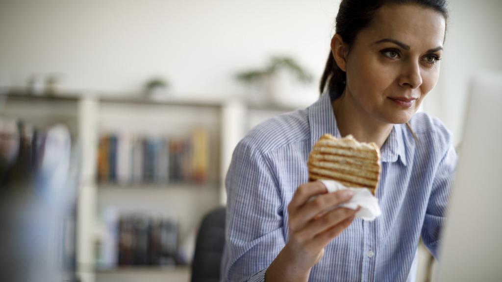 Una mujer, comiendo.
