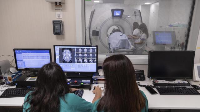 Dos sanitarias realizan un escáner a un paciente.