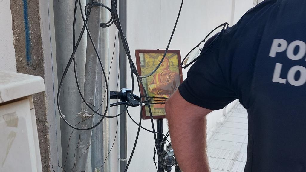 Un agente de la Policía Local de Adra junto al patinete con una foto de Franco.