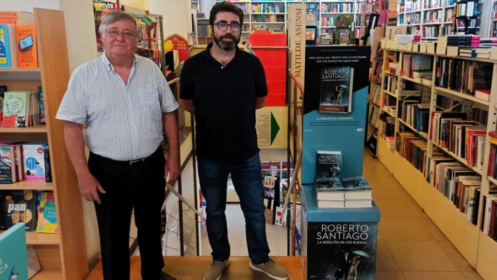 Paco y David posan ante las escaleras que dan acceso al sótano de la librería.