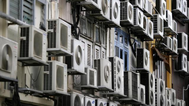 Edificio con aparatos de aire acondicionado en todas sus ventanas.