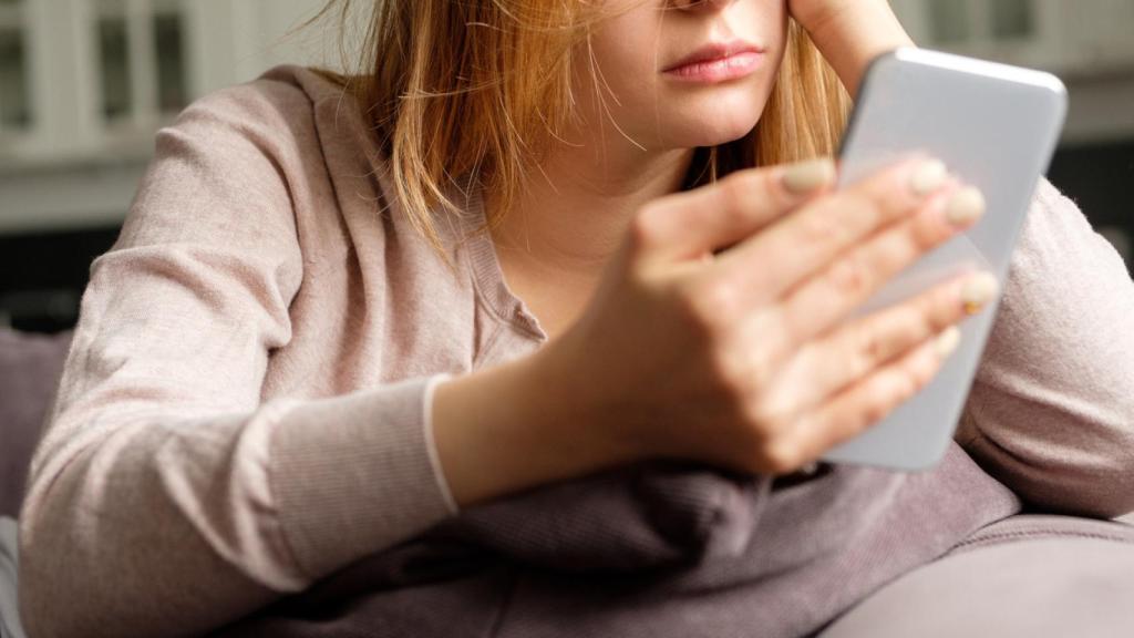 Una chica joven mirando el móvil. Foto: iStock.