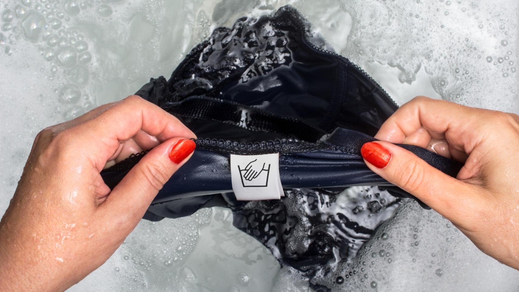 Una mujer, lavando la ropa a mano.
