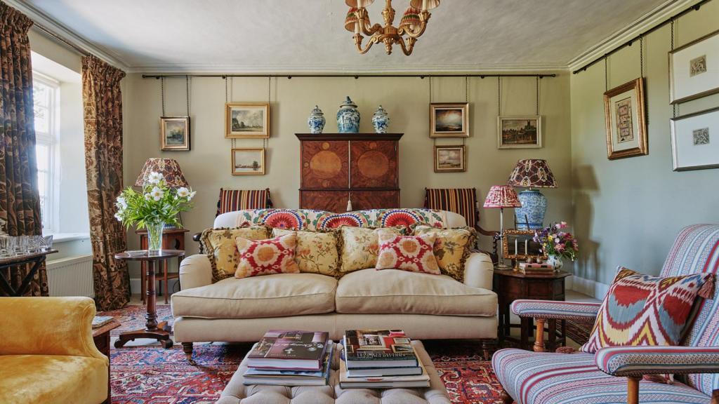 Sala de estar de Manor Farmhouse. Sobre el sofá, ikats de Estambul y cortinas de Robert Kime