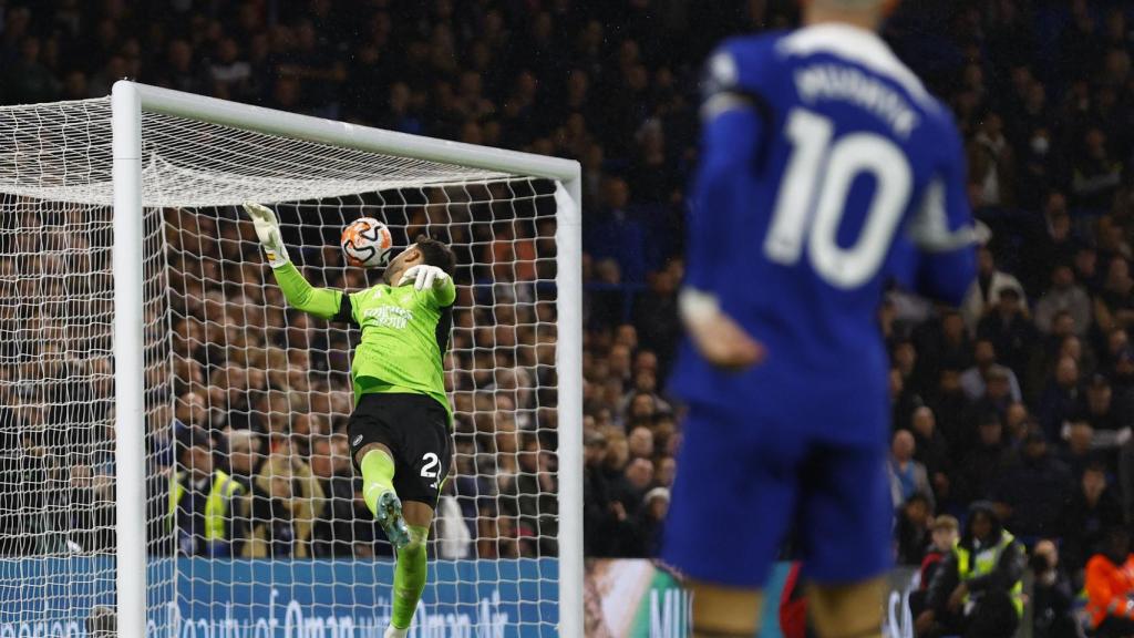 Mudryk, del Chelsea, trata de batir a Raya, el guardameta del Arsenal.