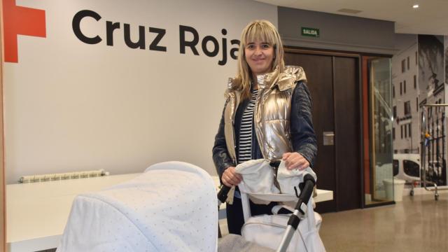 Belén, madre de acogida, posa con su bebé en la sede autonómica de Cruz Roja