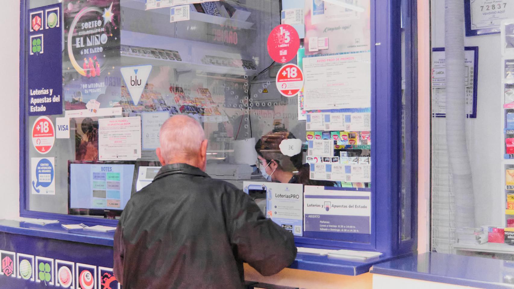 Un hombre acude a una administración de Lotería a comprar cupones.