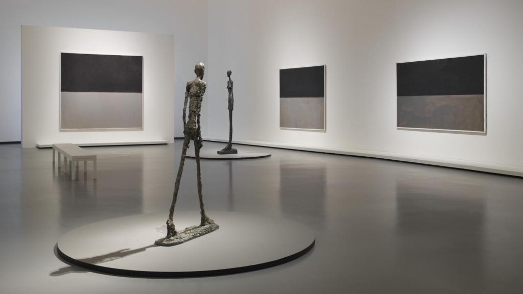 Vista de la sala dedicada al negro y el gris y esculturas de Alberto Giacometti 'L’Homme qui marche I' (1960) y 'Grande Femme III' (1960). © 1998 Kate Rothko Prizel & Christopher Rothko - Adagp, París, 2023